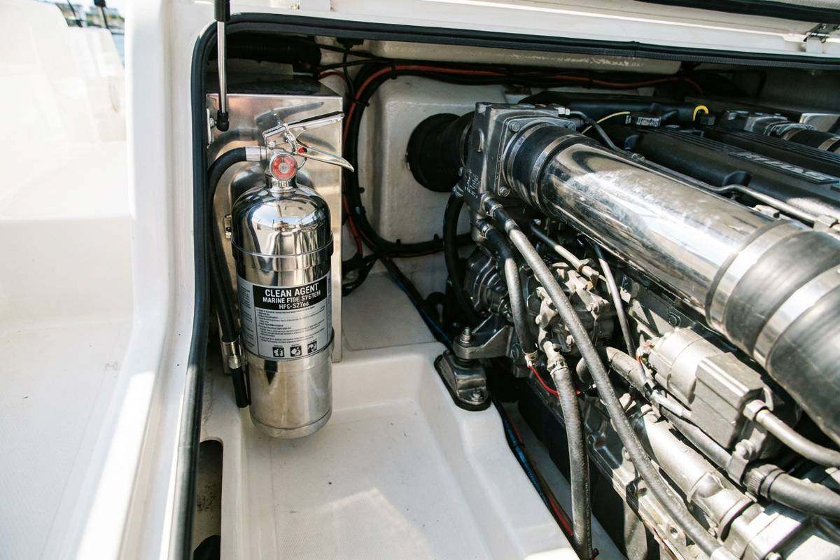 Compact clean agent fire extinguisher mounted in a boat engine compartment